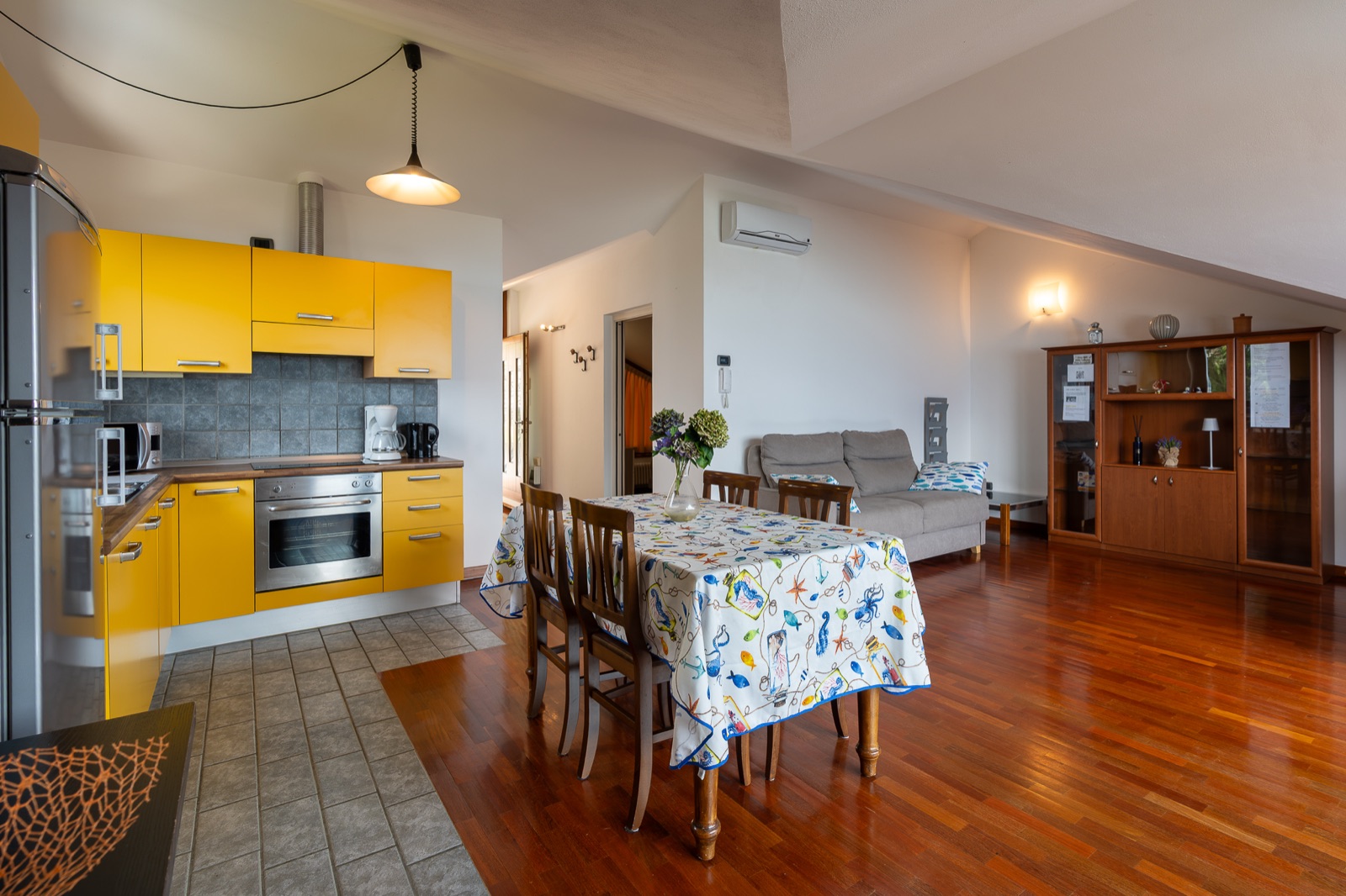 Cucina gialla con tavolo da pranzo e divano